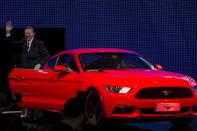 Ford Motor Co. CEO Alan Mulally waves as he gets off a new Ford Mustang on his arrival at the China Auto show in Beijing, China, Sunday, April 20, 2014. Ford joins a trend led by brands including GM's Cadillac unit that include features intended to appeal to Chinese tastes in models sold globally. (AP Photo/Ng Han Guan)