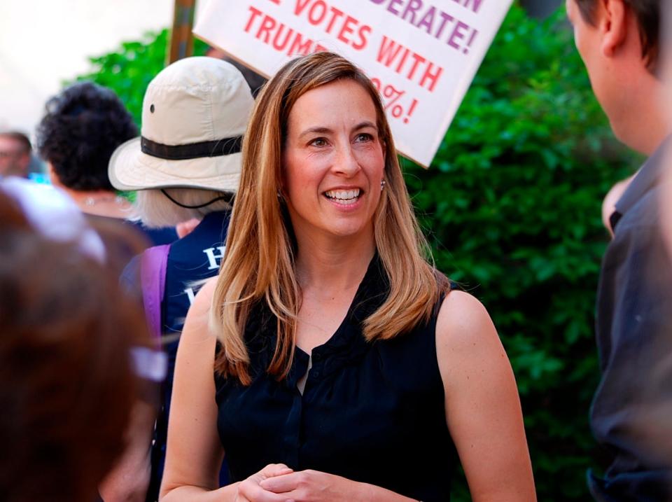 FILE- In this May 19, 2017, file photo, Mikie Sherrill joins protesters with NJ 11th for Change outside of U.S. Rep. Rodney Frelinghuysen's Morristown office.