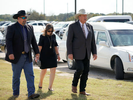 Wilson County Sheriff Joe Tackitt (R) arrives with two others at a funeral for six members of the Holcombe family and three members of the Hill family, victims of the Sutherland Springs Baptist church shooting, in Floresville, Texas, U.S., November 15, 2017. REUTERS/Darren Abate