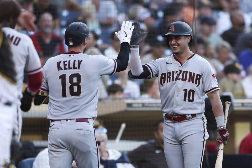 Arizona Diamondbacks' Carson Kelly (18) is congratulated by Josh Rojas (10) after Kelly's two-run home run against the San Diego Padres during the fifth inning of a baseball game Saturday, July 16, 2022, in San Diego. (AP Photo/Derrick Tuskan)