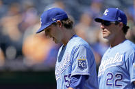 Kansas City Royals starting pitcher Daniel Lynch is followed to the dugout by Mike Matheny (22) as he comes out of the game during the third inning of a baseball game Thursday, Sept. 16, 2021, in Kansas City, Mo. (AP Photo/Charlie Riedel)