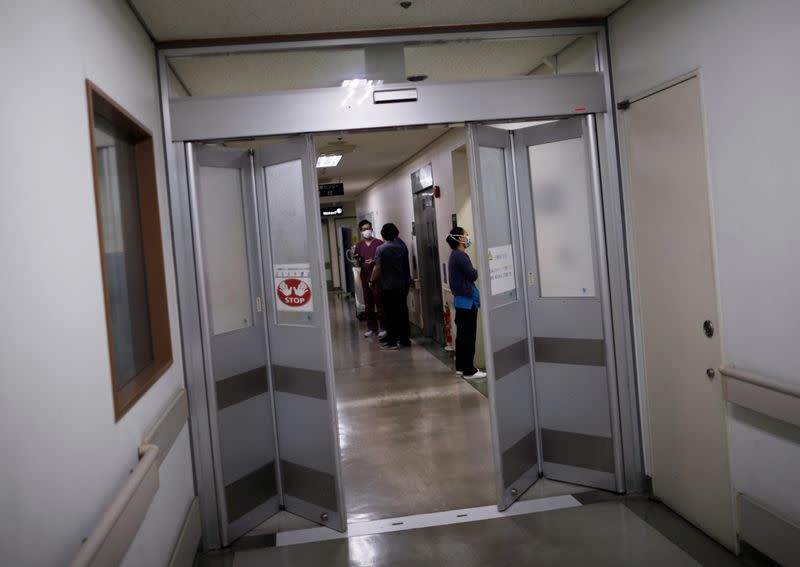 Medical workers are seen at the doors to the ICU for the coronavirus disease (COVID-19) patients at St. Marianna Medical University Hospital in Kawasaki, Japan