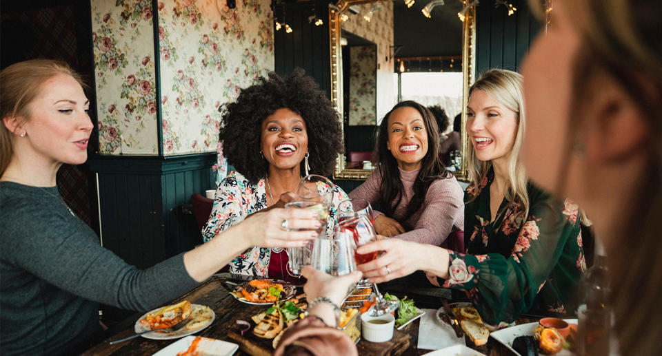 Women celebrating Galentine's Day over a meal. (Getty Images)