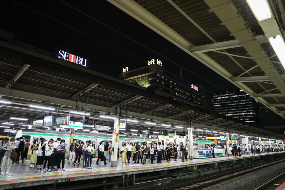 A photograph of commuters waiting for the train at at Ikebukuro Station on July 21, 2020 in Tokyo, Japan.