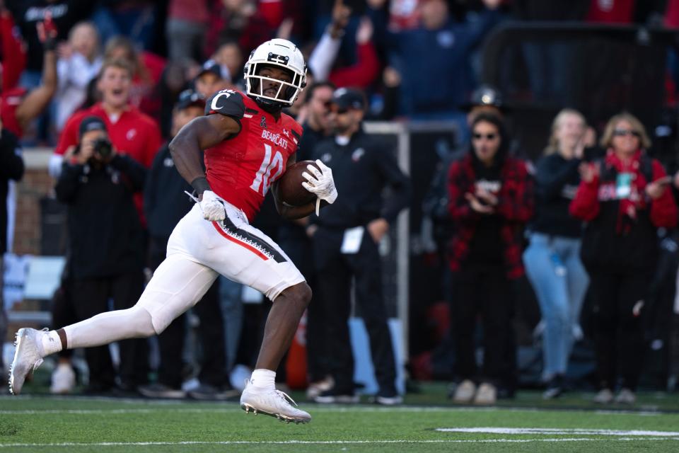 Cincinnati Bearcats running back Charles McClelland (10) looks back before scoring a touchdown to take the lead in the fourth quarter of the NCAA Football game at Nippert Stadium in Cincinnati on Saturday, Oct. 8, 2022. Cincinnati Bearcats defeated South Florida Bulls 28-24. 