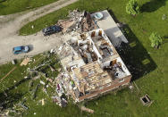 Storm damaged homes remain after a tornado passed through the area the previous evening, Tuesday, May 28, 2019, in Brookville, Ohio. (AP Photo/John Minchillo)