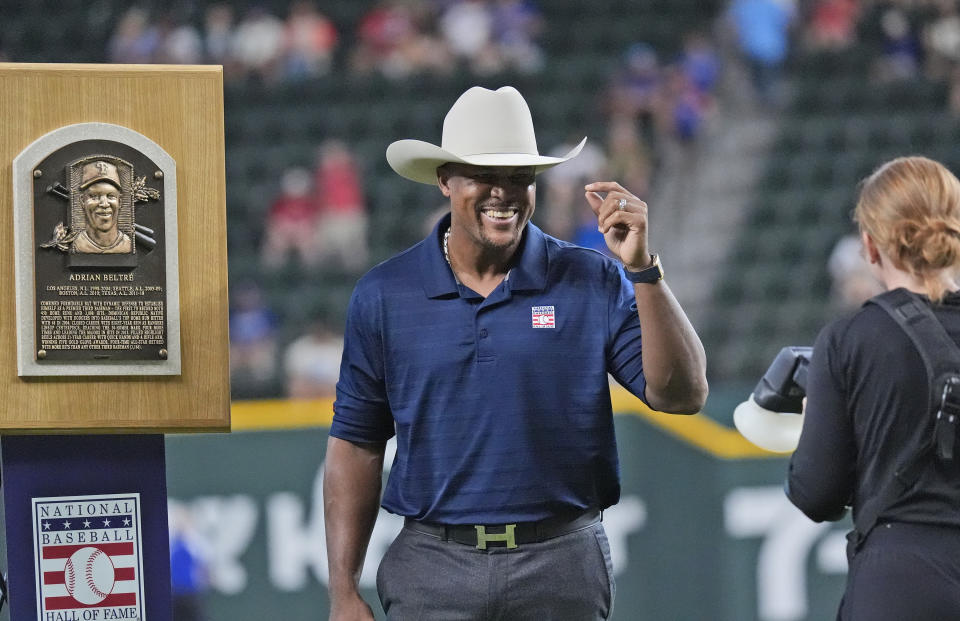 Former Texas Rangers third baseman Adrian Beltre smiles during a ceremony honoring his induction into the Hall of Fame before a baseball game between the Minnesota Twins and the Texas Rangers in Arlington, Texas, Saturday, Aug. 17, 2024. (AP Photo/LM Otero)