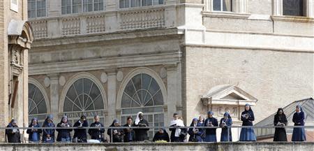 Nuns pray as Pope Francis leads the Palm Sunday mass at Saint Peter's Square in the Vatican April 13, 2014. REUTERS/Giampiero Sposito