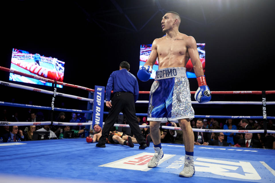 FILE - In this Feb. 2, 2019, file photo, Teofimo Lopez walks away after defeating Diego Magdaleno during a lightweight boxing match in Frisco, Texas. Vasiliy Lomachenko fights Teofimo Lopez on Saturday, Oct. 17, 2020, in Las Vegas. Boxing fans should be thankful. They’re getting a quality fight _ and they’re getting it for free.(AP Photo/Cooper Neill, File)