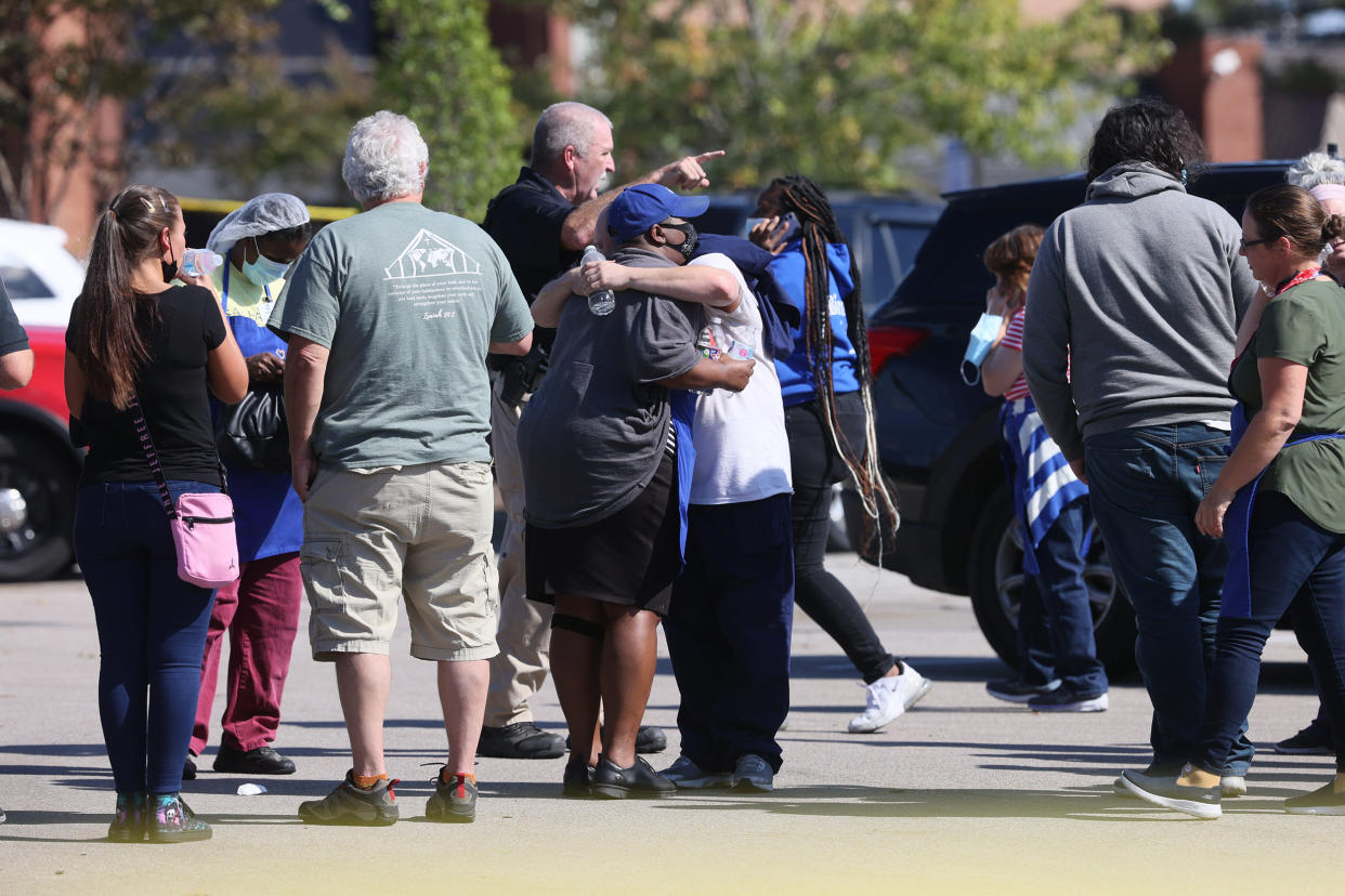 Image: People hug outside the Kroger in Collierville, Tenn., at the scene of a shooting on Sept. 23, 2021. (Joe Rondone / The Commercial Appeal / USA Today Network)