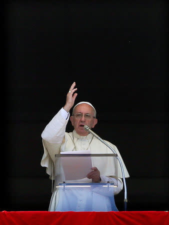 Pope Francis blesses as he leads the Angelus prayer in Saint Peter's Square at the Vatican August 15, 2016. REUTERS/Max Rossi/File Photo