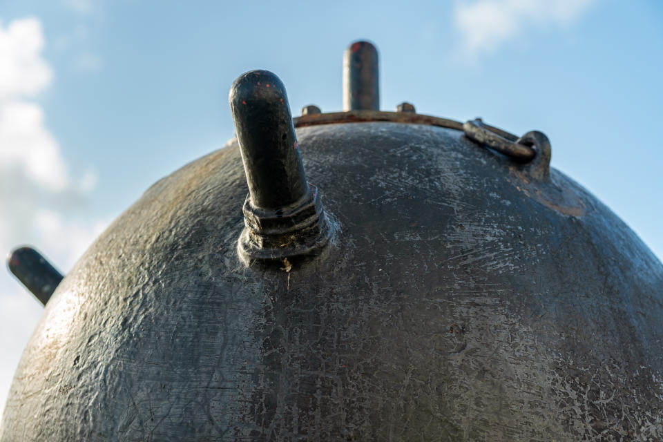 Close up of an old black contact mine or naval mine with large trigger horns