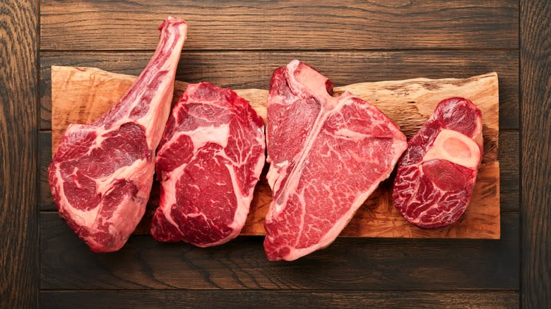 different cuts of steak on chopping board