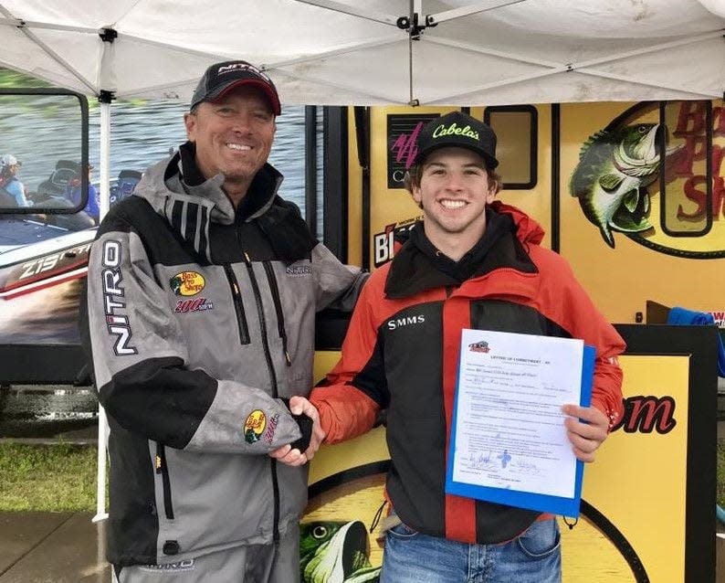 Drury fishing coach Rick Emmitt, left, and Helena, Montana native Lee Lambrecht,  after signing his letter of intent in 2019. Lambrecht is now a senior.