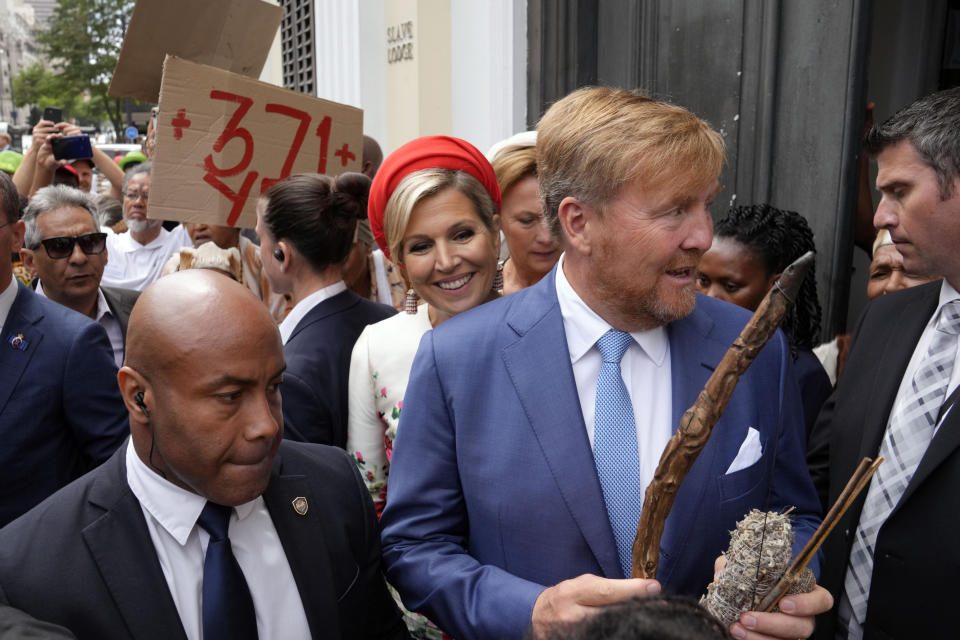 Khoisan protesters surround King Willem Alexander and Queen Maxima of the Netherlands at the Iziko Slave Lodge museum in Cape Town during their state visit to South Africa Friday, Oct. 20, 2023. The king and queen of the Netherlands were confronted by angry protesters in South Africa on a visit Friday to a monument that traces part of their country's involvement in slavery as a colonial power 300 years ago. (AP Photo/Nardus Engelbrecht)