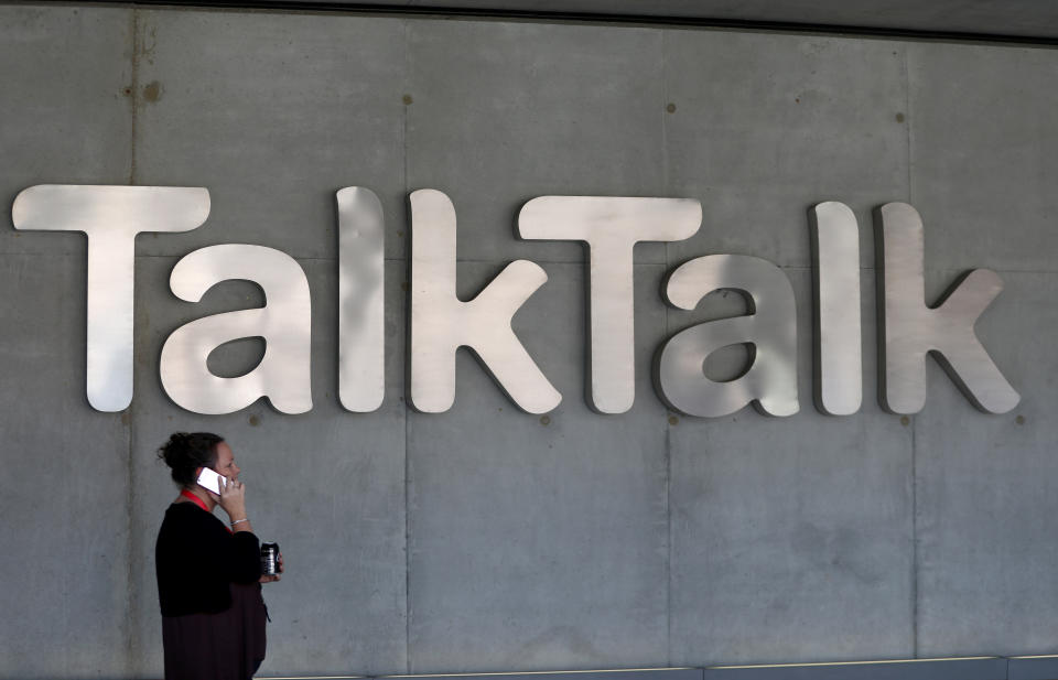 A woman speaks on her phone as she passes a branded logo outside the Talktalk headquarters in London, Britain May 10, 2017. REUTERS/Neil Hall