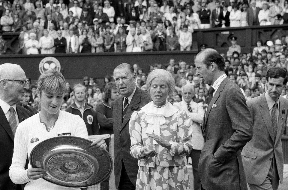 FILE - Chris Evert Lloyd admires her trophy, as the Duchess of Kent applauds, following the presentation ceremony on Wimbledon's Centre Court, Friday, July 3, 1981. Chris Evert appreciates that she, Serena Williams and other Wimbledon women's singles champions will now be listed on the All England Club's honor boards in a Centre Court hallway simply by their first initial and last name — the way the men's title winners always have been — instead of preceded by “Miss” or “Mrs.” (AP Photo/Bob Dear, File)