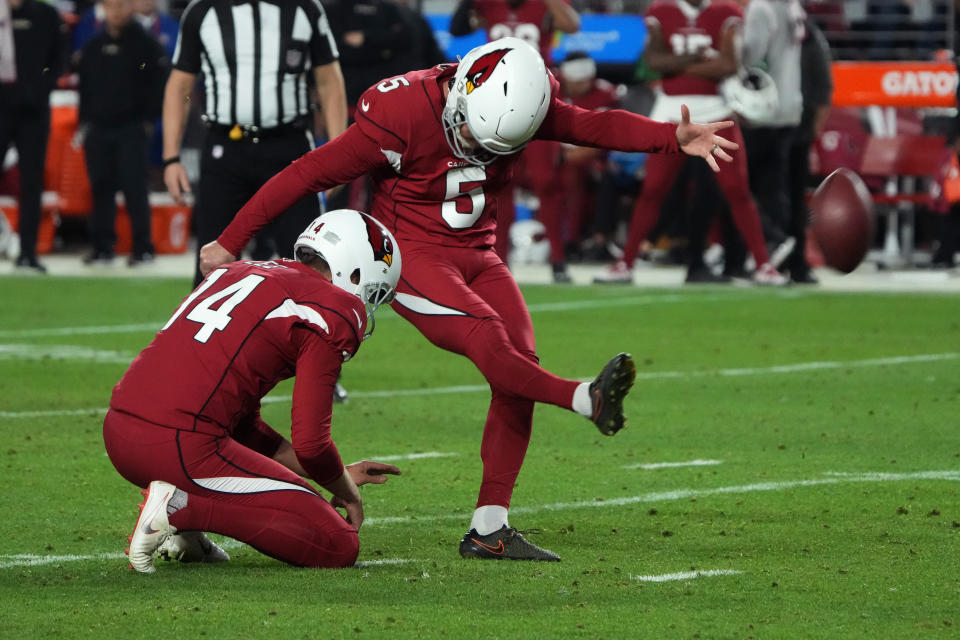 Arizona Cardinals place kicker Matt Prater (5) kick a field goal as punter Andy Lee (14) holds against the Tampa Bay Buccaneers during the second half of an NFL football game, Sunday, Dec. 25, 2022, in Glendale, Ariz. (AP Photo/Rick Scuteri)