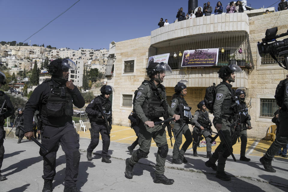 Israeli police march in the east Jerusalem neighborhood of Silwan, Friday, Feb. 10, 2023. In the area of Wadi Qaddum earlier on Friday, Palestinians held midday prayers in protest outside an apartment building housing 100 residents that is slated to be razed. Netanyahu's office has reportedly delayed the demolition. (AP Photo/Mahmoud Illean)