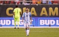 Jun 26, 2016; East Rutherford, NJ, USA; Argentina midfielder Lionel Messi (10) reacts after missing a shot during the shoot out round against Chile in the championship match of the 2016 Copa America Centenario soccer tournament at MetLife Stadium. Mandatory Credit: Adam Hunger-USA TODAY Sports