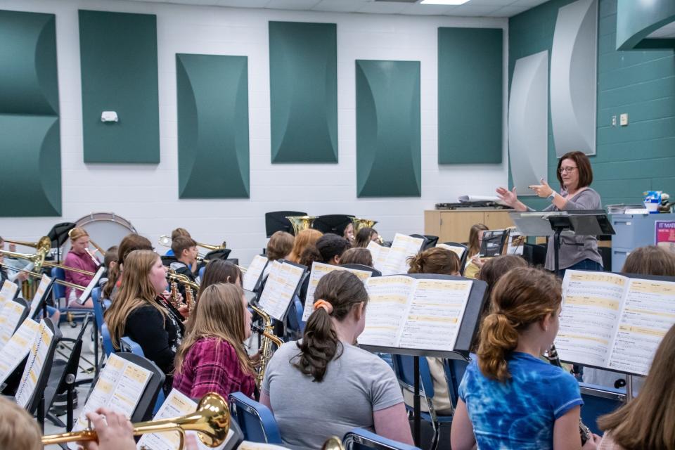 Michele Haverfield (right) teaches her seventh grade band class at Cambridge Middle School.