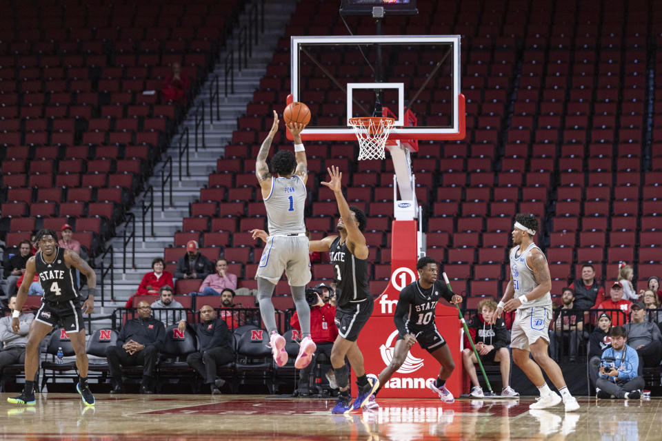 Drake's Roman Penn (1) makes a jump shot against Mississippi State's Tolu Smith (1) late in the second half of an NCAA college basketball game, Tuesday, Dec. 20, 2022, in Lincoln, Neb. (AP Photo/John S. Peterson)