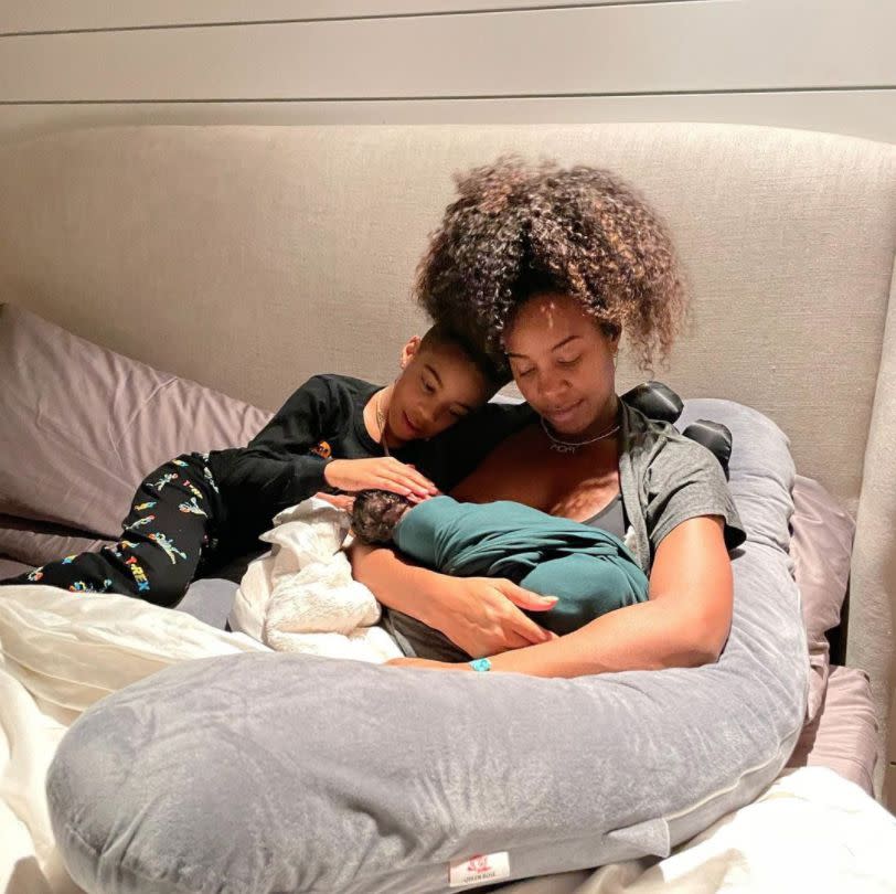 Kelly Rowland is all smiles in her "Happy Place" surrounded by son Titan, 6, and newborn Noah. The 40-year-old singer welcomed her second child with husband Tim Weatherspoon on Jan. 21, 2021.