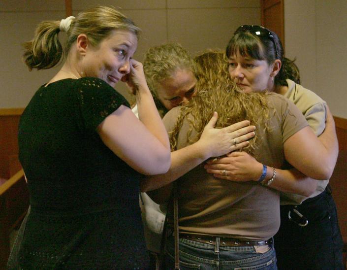 Ashley Koester, the wife of slain Lake County Deputy Wayne Koester, center, is comforted by two friends as Koester's sister-in-law, Jonel Koester, left, wipes tears after Jason Wheeler was found guilty of first degree murder of a law enforcement officer with a firearm, two counts of attempted murder of a law enforcement officer and two counts of aggravated battery of a law enforcement officer at the Lake County Judicial Center in Tavares, Fla. on Friday, May 19, 2006.