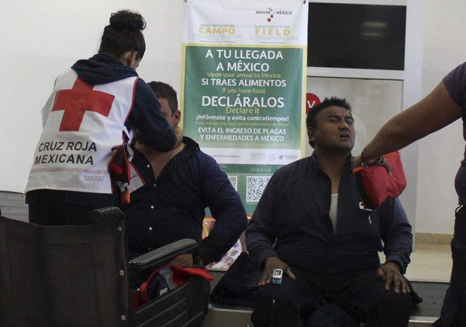 <p>In this photo released by Red Cross Durango communications office, Red Cross workers attend airline passengers who survived a plane crash, at the airport baggage area in Durango, Mexico, Tuesday, July 31, 2018. (Photo: Red Cross Durango via AP) </p>