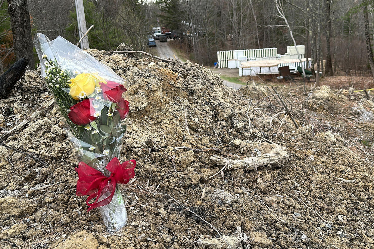 A lone bouquet of flowers marks a desolate makeshift memorial at the end of a driveway at a Bowdoin, Maine, home, Wednesday, April 19, 2023, where four people were killed. (AP Photo/Rodrique Ngowi)