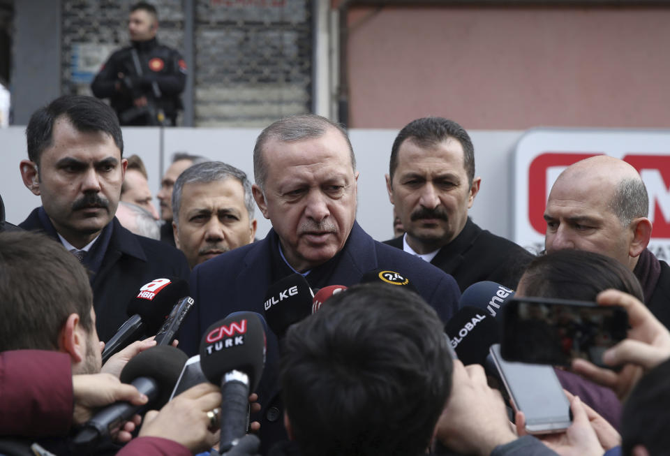 Turkey's President Recep Tayyip Erdogan speaks to the media as he visits the site of a collapsed building in Istanbul, Saturday, Feb. 9, 2019. Erdogan says there are "many lessons to learn" from the collapse of a residential building in Istanbul where at least 17 people have died. (Presidential Press Service via AP, Pool)