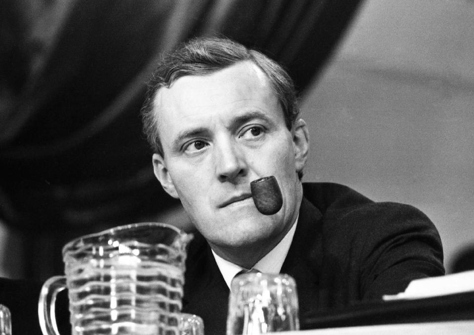 FILE - In this Oct. 3, 1967 file photo, Tony Benn puffs on his pipe as he listens to speeches during the second day of the 66th annual Labour Party Conference, in Scarborough, England. Tony Benn, a committed British socialist who irritated, fascinated _ and bored _ Britons through a political career spanning more than five decades and who renounced his aristocratic title rather than leave the House of Commons, has died. He was 88. (AP Photo/Laurence Harris, File)