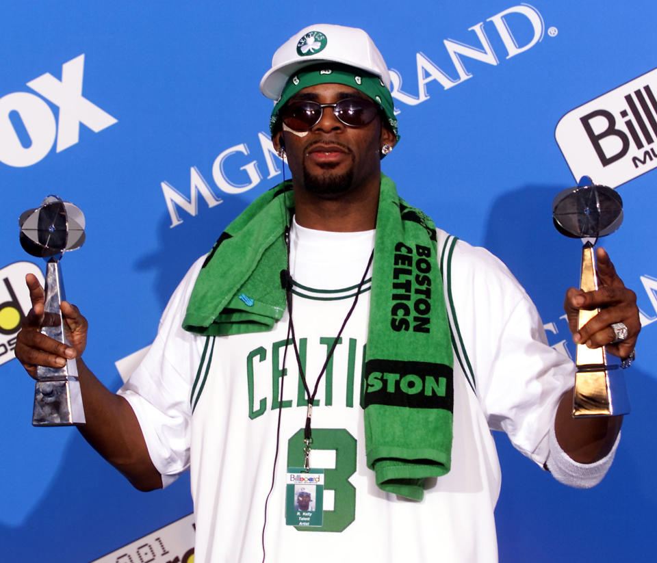 FILE - R. Kelly holds two of his six awards as he poses for photographers during the 2001 Billboard Music Awards, Tuesday, Dec. 4, 2001, in Las Vegas. Kelly's album "TP-2.com" debuts at No. 1 on the Billboard album chart. The 54-year-old R&B singer will once again head to court this week. His federal trial in New York begins Wednesday, Aug. 18. 2021, and will explore years of sexual abuse allegations. He has vehemently denied the allegations against him. (AP Photo/Eric Jamison, File)