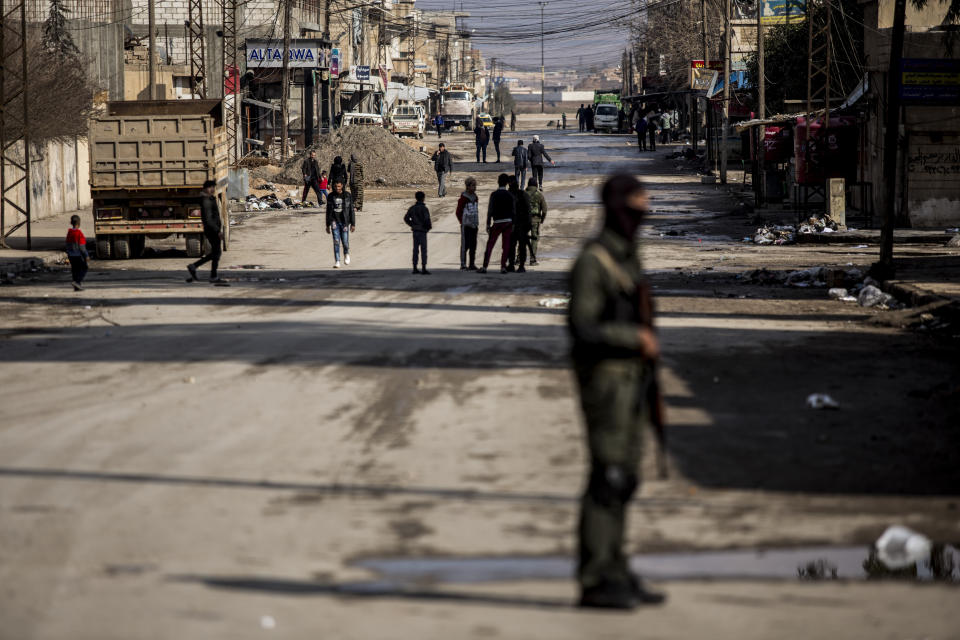 Civilians return to the city after fighting subsideds in Hassakeh, Syria, Sunday, Jan. 30, 2022. The Islamic State group's Jan. 20 attack on the prison in Hassakeh was the biggest military operation by the extremist group since the fall of their self-declared caliphate in 2019. (AP Photo/Baderkhan Ahmad)