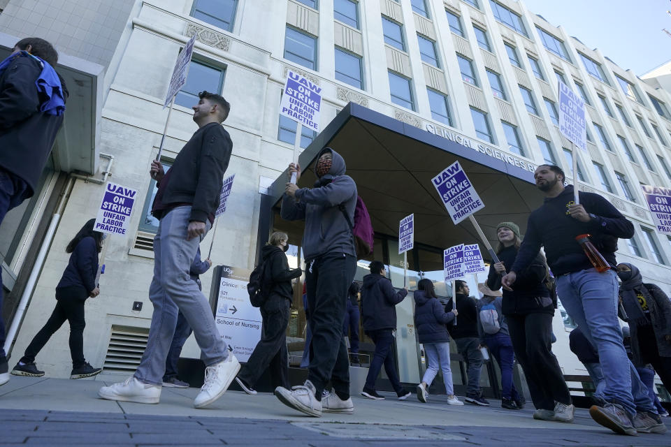 People take part in a protest outside of University of California San Francisco medical offices in San Francisco, Monday, Nov. 14, 2022. Nearly 48,000 unionized academic workers at all 10 University of California campuses have walked off the job Monday. (AP Photo/Jeff Chiu)