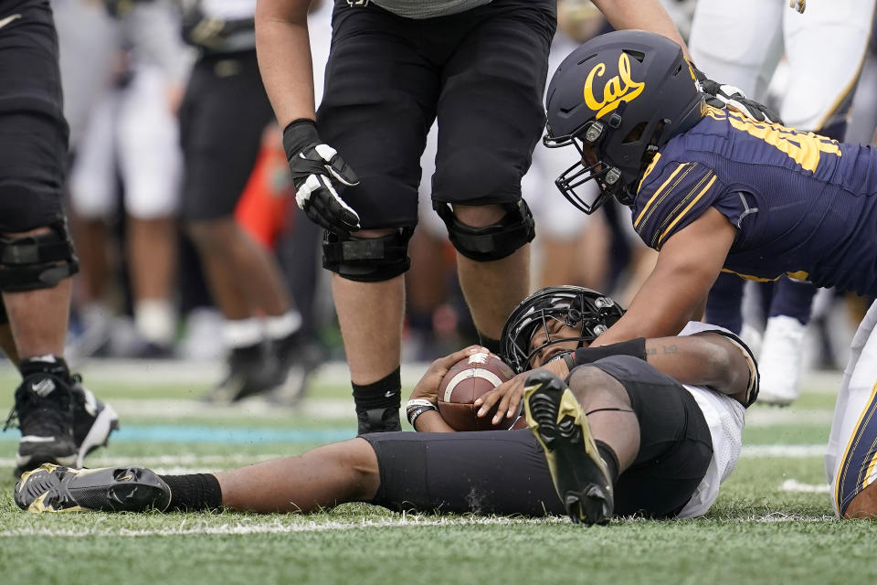 Colorado quarterback Brendon Lewis, bottom, reacts after being sacked by California linebacker Orin Patu, right, during the second half of an NCAA college football game in Berkeley, Calif., Saturday, Oct. 23, 2021. (AP Photo/Jeff Chiu)