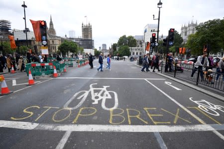 A writing on the roadside that reads "Stop Brexit" is seen near the Houses of Parliament in London