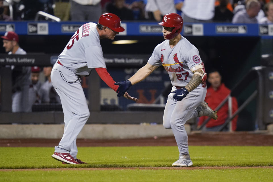 St. Louis Cardinals third base coach Ron "Pop" Warner celebrates with Tyler O'Neill, right, after O'Neill hit a two-run home run during the eighth inning of the team's baseball game against the New York Mets on Tuesday, Sept. 14, 2021, in New York. (AP Photo/Frank Franklin II)