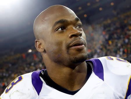 Minnesota Vikings running back Adrian Peterson leaves the field after a season-ending loss to the Green Bay Packers in Green Bay, Wisconsin, in this file photo taken January 5, 2013. REUTERS/Tom Lynn/Files