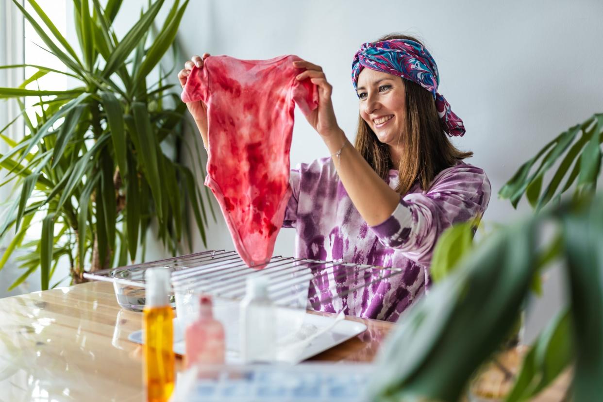 woman making tie-dye baby clothes