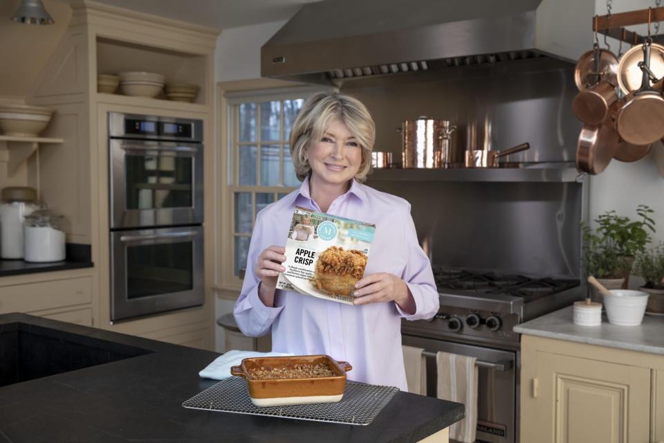 martha stewart in kitchen holding frozen apple crips