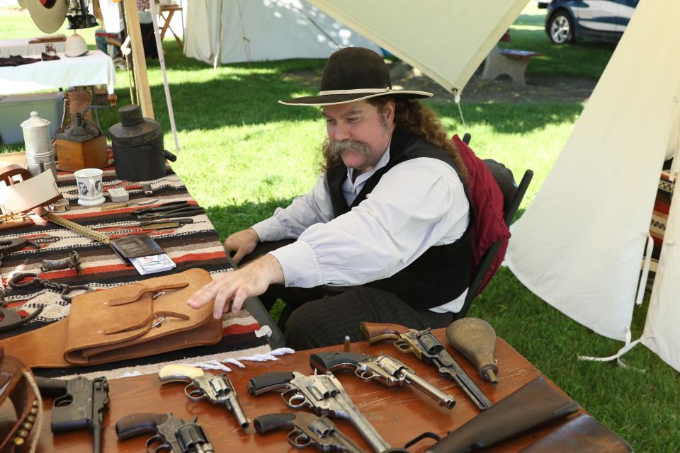 Jason Adams, organizer of the Old Timey Days event in Gibsonburg, displays his collection of antique hand guns. The fourth annual event was held at Williams Park on May 18 and 19.