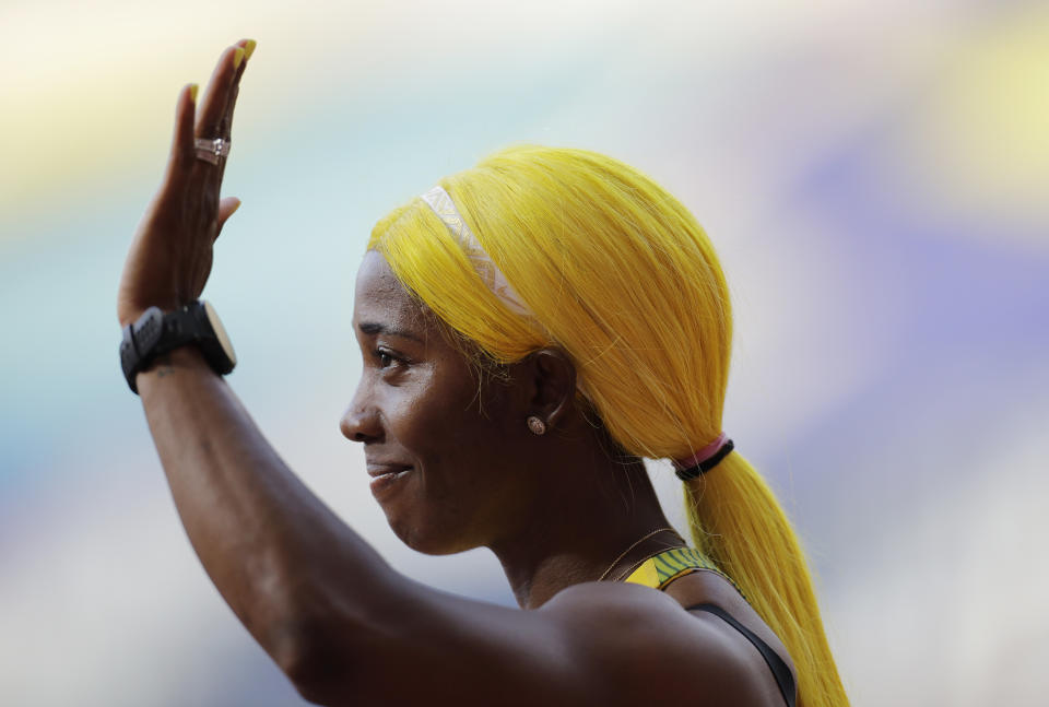 Shelly-Ann Fraser-Pryce, of Jamaica, waves after finishing at the women's 100 meter heat at the World Athletics Championships in Doha, Qatar, Saturday, Sept. 28, 2019. (AP Photo/Petr David Josek)