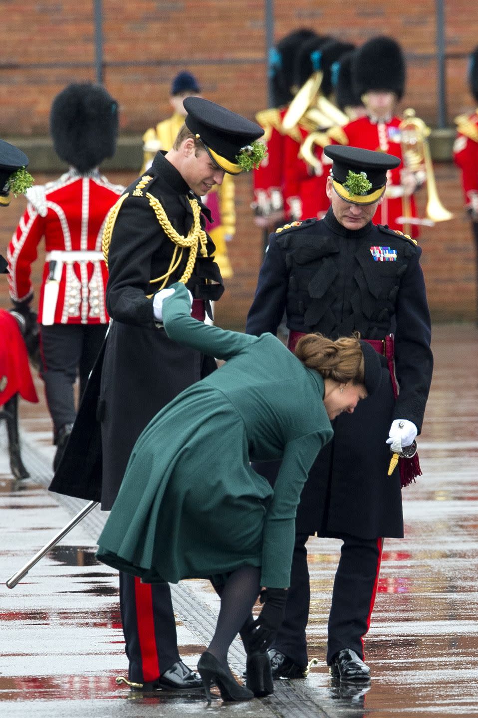 <p>Catherine, Duchess of Cambridge holds on to Prince William as she pulls her heel out of a grate it got stuck in. </p>