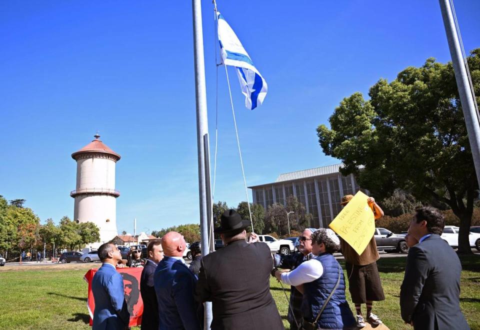 The City of Fresno raised an Israeli flag in solidarity with Israel in a ceremony at Eaton Plaza Thursday, Oct. 12, 2023 in downtown Fresno. Around 60 people attended the event including supporters of the Palestinian people who stoof at the fringe of those assembled.