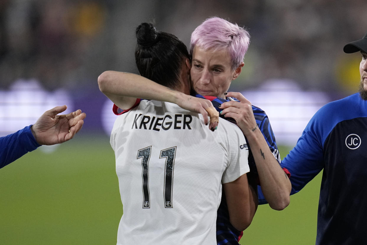 OL Reign forward Megan Rapinoe, right, embraces NJ/NY Gotham defender Ali Krieger as Rapinoe comes off the field after an injury during the first half of the NWSL Championship soccer game, Saturday, Nov. 11, 2023, in San Diego. (AP Photo/Gregory Bull)