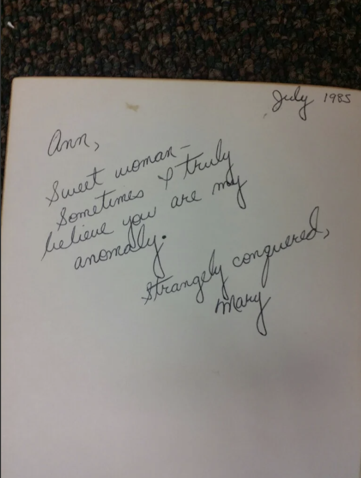 A handwritten note reads: "Ann, Sweet woman—sometimes I truly believe you are my anomaly. Strangely conquered, Mary." Dated July 1985