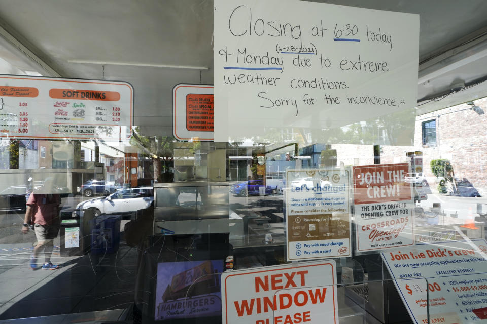 A sign in the window of the Dick's Drive-In in Seattle's Capitol Hill neighborhood is shown Monday, June 28, 2021, in Seattle. The walk- and drive-up restaurant, which is not air conditioned, closed early Sunday and all day Monday due to excessive heat. Seattle and other cities in the Pacific Northwest endured the hottest day of an unprecedented and dangerous heat wave on Monday, with temperatures obliterating records that had been set just the day before on Sunday. (AP Photo/Ted S. Warren)