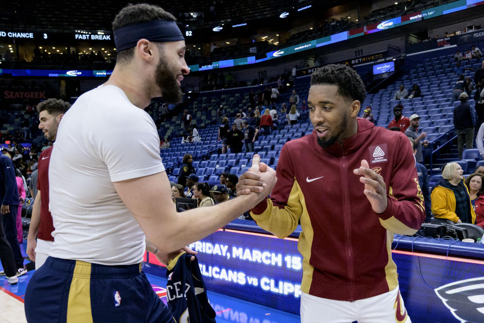 New Orleans Pelicans forward Larry Nance Jr., left, greets Cleveland Cavaliers guard Donovan Mitchell after the Cavaliers defeated the Pelicans in an NBA basketball game in New Orleans, Wednesday, March 13, 2024. (AP Photo/Matthew Hinton)