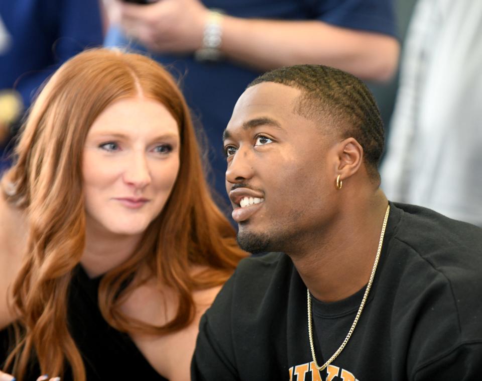 Former McKinley High School quarterback Dominique Robinson watches the screen as wife Emma looks on as he is drafted by the Bears in the fifth round of the NFL Draft surrounded by friends and family at Stark State Business and Entrepreneurial Center, Saturday.